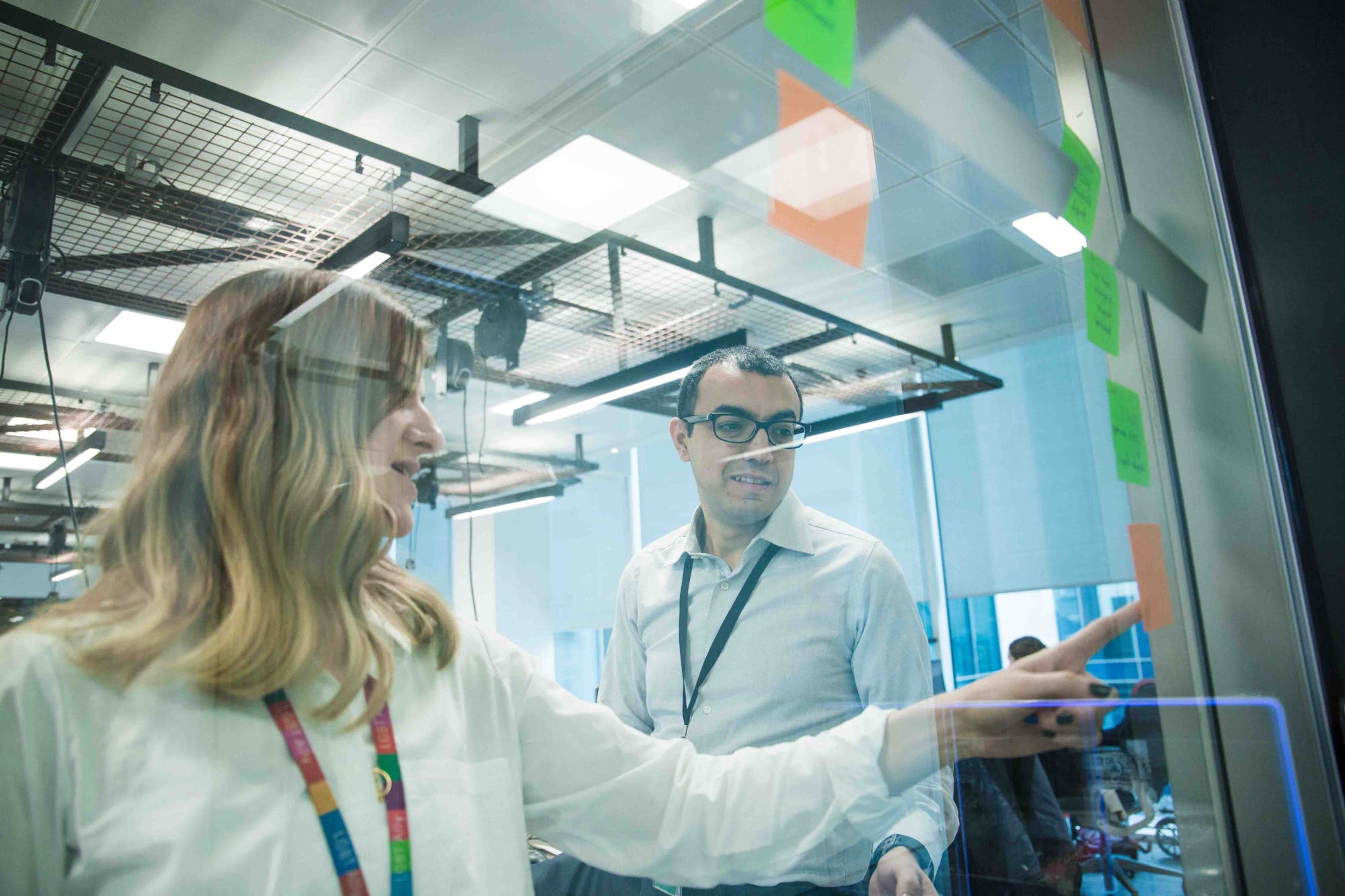 People collaborating at a glass wall inside The Dock, Accenture’s Dublin research and incubation hub, in a 2017 official photograph